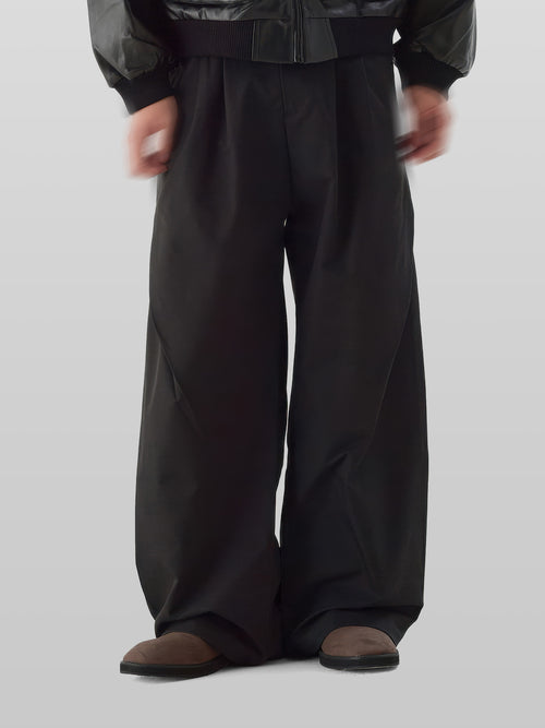 3D Side Cross Tuck Pants black – Front view | wide-leg / pleated / relaxed tailoring | UNPROVEN