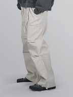 Nylon Zip Pants ivory – Front view | wide-leg / pleated / relaxed tailoring | UNPROVEN